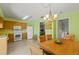 Open kitchen and dining area featuring tile floors and updated appliances at 888 Kimball Rd, Venice, FL 34293