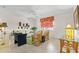 Bright living room featuring tile floors, a ceiling fan, and floral patterned decor at 888 Kimball Rd, Venice, FL 34293