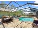 Inviting screened pool with outdoor seating and dining area perfect for relaxation and entertaining at 888 Kimball Rd, Venice, FL 34293