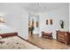 Bedroom with a cozy daybed, tiled floors, and bright natural light at 9413 Carnaby Dr, Venice, FL 34293