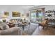 Bright living room with comfortable seating, stylish decor, and sliding glass doors leading to an outdoor space at 9413 Carnaby Dr, Venice, FL 34293