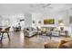 Spacious living room with a dining area, neutral decor, and ample seating, creating an inviting and comfortable atmosphere at 9413 Carnaby Dr, Venice, FL 34293