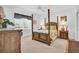 Spacious main bedroom with four-poster bed, providing a relaxing retreat at 9413 Carnaby Dr, Venice, FL 34293