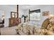 Main bedroom showcasing a four-poster bed, natural light, and dresser at 9413 Carnaby Dr, Venice, FL 34293