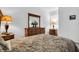 Comfortable main bedroom featuring classic decor and an accent mirror at 9413 Carnaby Dr, Venice, FL 34293