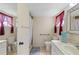 Well-lit bathroom with a shower, toilet, sink, and tiled floor, offering a clean and functional space at 942 Capri Isles Blvd # 105, Venice, FL 34292