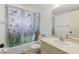 Bathroom with a butterfly shower curtain, toilet, and vanity, offering a functional and aesthetically pleasing space at 942 Capri Isles Blvd # 105, Venice, FL 34292