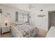 Cozy bedroom featuring a bed with a floral quilt, with two windows and a closet for storage at 942 Capri Isles Blvd # 105, Venice, FL 34292