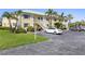Inviting two-story condo featuring a well-maintained facade, lush landscaping and parking at 942 Capri Isles Blvd # 105, Venice, FL 34292