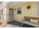 Charming front porch with cozy seating, a decorative sun accent, and a welcoming entrance at 942 Capri Isles Blvd # 105, Venice, FL 34292