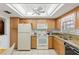 Well-lit kitchen features bright cabinets, granite countertops, and tile flooring at 942 Capri Isles Blvd # 105, Venice, FL 34292