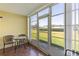 The lanai is a screened outdoor space with room for seating with views of the green lawn at 942 Capri Isles Blvd # 105, Venice, FL 34292