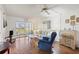 Bright living room with tile floors and sliding glass doors to a screened-in lanai at 942 Capri Isles Blvd # 105, Venice, FL 34292
