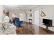 Open living area with wood floors, comfortable seating, and seamless flow to other rooms at 942 Capri Isles Blvd # 105, Venice, FL 34292