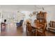 Open living room featuring wood flooring, a dining set, and glass doors to the patio at 942 Capri Isles Blvd # 105, Venice, FL 34292