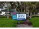 Well-maintained Venice Beach sign with lush greenery, showcasing the entrance to the beautiful Sarasota County beach at 942 Capri Isles Blvd # 105, Venice, FL 34292