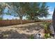 Spacious backyard surrounded by a wooden fence and trees with landscaped garden at 10047 Greetings St, Port Charlotte, FL 33981