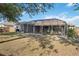 The backyard features a screened-in patio, offering a private space for outdoor living at 10047 Greetings St, Port Charlotte, FL 33981