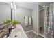 Bathroom featuring a double vanity, modern fixtures, and a glass-enclosed shower at 10047 Greetings St, Port Charlotte, FL 33981