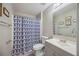 Bathroom featuring a shower with patterned curtain and framed mirror, sink and light grey walls at 10047 Greetings St, Port Charlotte, FL 33981