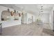 Open-concept room featuring hard surface floors, a dining table set, and natural lighting at 10047 Greetings St, Port Charlotte, FL 33981