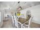 Open concept living with clear view of the kitchen and dining room, complete with a table set and light hardwood flooring at 10047 Greetings St, Port Charlotte, FL 33981