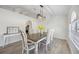 Elegant dining room with modern light fixture, comfortable seating, bright light and stylish decor, with an open floor plan at 10047 Greetings St, Port Charlotte, FL 33981