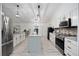 Modern kitchen with stainless steel appliances, large island, and stylish finishes provides a culinary haven at 10047 Greetings St, Port Charlotte, FL 33981