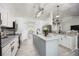 Well-lit kitchen showcasing sleek appliances, a central island, and elegant countertops perfect for cooking at 10047 Greetings St, Port Charlotte, FL 33981