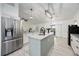 Modern kitchen featuring stainless steel appliances, a large island, and ample workspace for meal prep at 10047 Greetings St, Port Charlotte, FL 33981