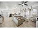 Bright living room with hardwood floors, natural light, and cozy seating creates an inviting atmosphere at 10047 Greetings St, Port Charlotte, FL 33981