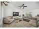 Comfortable living area with hardwood floors, soft seating, and natural light offers a cozy retreat at 10047 Greetings St, Port Charlotte, FL 33981