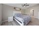 Bedroom with light grey floors, ceiling fan and a white wooden bed frame and headboard at 10047 Greetings St, Port Charlotte, FL 33981
