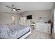 Beautiful main bedroom with a ceiling fan, tv, and a full dresser with a vanity at 10047 Greetings St, Port Charlotte, FL 33981