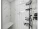 Elegant shower with marble-look tiles, a built-in bench, and modern black fixtures at 10047 Greetings St, Port Charlotte, FL 33981