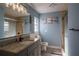 Nicely updated bathroom with granite vanity, updated lighting, and a shower at 1008 Euclid Rd, Venice, FL 34293
