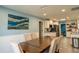 Dining room featuring a large wooden table, seating for six, and artwork on the wall at 1008 Euclid Rd, Venice, FL 34293