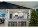 A kitchen pass-through and bar with white cabinets and blue accent lighting gives a modern beach-inspired feel at 1008 Euclid Rd, Venice, FL 34293
