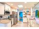 Bright kitchen featuring stainless steel appliances, granite countertops, and open shelving at 1008 Euclid Rd, Venice, FL 34293