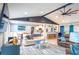 Open concept living room featuring a ceiling fan, multiple sofas, and views to the kitchen and dining area at 1008 Euclid Rd, Venice, FL 34293