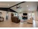 Bright living room has access to the pool and is decorated with comfortable seating, tile floors, and coastal decor at 1008 Euclid Rd, Venice, FL 34293