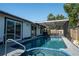Beautiful backyard pool and spa featuring screened enclosure and covered patio at 1008 Euclid Rd, Venice, FL 34293