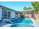 Inviting pool with a screened enclosure and a relaxing spa at 1008 Euclid Rd, Venice, FL 34293