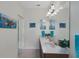 Bathroom featuring double sinks, a large mirror, wood cabinets, and tiled floors at 11007 Batello Dr, Venice, FL 34292