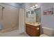 Cozy bathroom featuring a shower and tub combination, vanity, and soft, natural light at 11007 Batello Dr, Venice, FL 34292