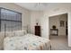 Comfortable bedroom with neutral walls, ceiling fan, and an inviting bed with seahorse patterned bedspread at 11007 Batello Dr, Venice, FL 34292