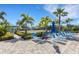 Outdoor bocce ball court with lounge chairs, set among well-manicured grounds for active leisure at 11007 Batello Dr, Venice, FL 34292