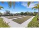 Recreational bocce ball court offering a relaxed outdoor activity, framed by lush landscaping at 11007 Batello Dr, Venice, FL 34292