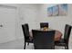 Cozy dining area featuring a round table, chairs, and bright wall art in a well-lit space at 11007 Batello Dr, Venice, FL 34292