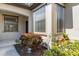 Home exterior featuring a bay window, lush landscaping, and a cozy front porch area at 11007 Batello Dr, Venice, FL 34292